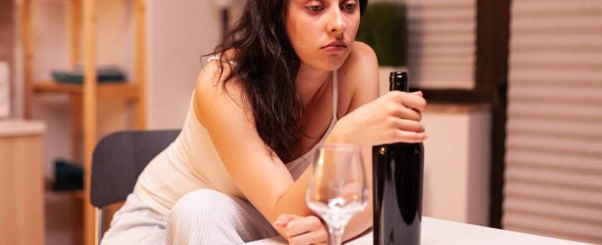 depressed woman drinking wine - alcohol use disorder